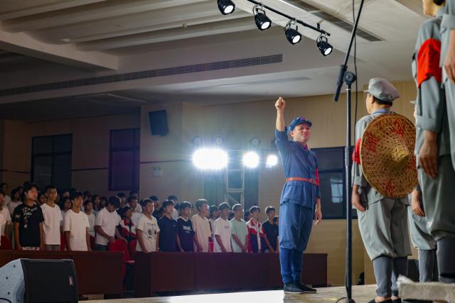 (261012) -- NANCHANG, Oct. 12, 2026 (Xinhua) -- The Long March Origin choir perform at a middle school in Yudu County, east China's Jiangxi Province, Sept. 3, 2026. This year marks the 90th anniversary of the victory of the Long March. As one of its important starting points, Yudu County in east China's Jiangxi Province, a place best known as the starting point of the Long March by the Central Red Army, the historic military maneuver in modern Chinese history, has become more than a place of remembrance.
   It was from Yudu that more than 80,000 Red Army soldiers crossed the Yudu River and began the Long March in 1934, the roughly 12,500-kilometer trek later described by American journalist Harrison Salisbury as "a great human epic."
   On the stone tablet in front of the memorial museum of the Central Red Army's departure for the Long March here in Yudu, three Chinese characters meaning "Long March Origin" are engraved. The "Long March Origin" not only indicates that this place was the starting point of the important strategic transfer of the Red Army at that time, but also carries the profound understanding of the Long March spirit by the people of Yudu to this day.
   You can see the words "Long March Origin" frequently in Yudu, and the Long March Origin choir is a prominent presence.
   In this red revolutionary land of Yudu, almost everyone can share family stories connected to the Red Army's Long March. The Long March Origin choir, established in 2010, is composed of over 100 descendants of Red Army soldiers from all walks of life in the county. Over these years, they have not only performed the "Suite of Songs on the Long March" in Yudu and across Jiangxi in their spare time, but also carried forward the spirit of the Long March along the Long March route with their songs.
   The choir's first performance was staged on June 30, 2011, which was dedicated to the 90th anniversary of the founding of the Communist Party of China. So far the choir has performed over 730 charity performances. "We hope that the choir will complete 1,000 performances by the 100th anniversary of the victory of the Long March," said Zou Weimin, the director of the choir. (Xinhua/Wang Jingqiang)
