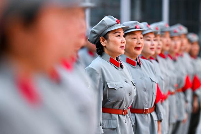 (261012) -- NANCHANG, Oct. 12, 2026 (Xinhua) -- The Long March Origin choir rehearse at the cultural center in Yudu County, east China's Jiangxi Province, July 28, 2026. This year marks the 90th anniversary of the victory of the Long March. As one of its important starting points, Yudu County in east China's Jiangxi Province, a place best known as the starting point of the Long March by the Central Red Army, the historic military maneuver in modern Chinese history, has become more than a place of remembrance.
   It was from Yudu that more than 80,000 Red Army soldiers crossed the Yudu River and began the Long March in 1934, the roughly 12,500-kilometer trek later described by American journalist Harrison Salisbury as "a great human epic."
   On the stone tablet in front of the memorial museum of the Central Red Army's departure for the Long March here in Yudu, three Chinese characters meaning "Long March Origin" are engraved. The "Long March Origin" not only indicates that this place was the starting point of the important strategic transfer of the Red Army at that time, but also carries the profound understanding of the Long March spirit by the people of Yudu to this day.
   You can see the words "Long March Origin" frequently in Yudu, and the Long March Origin choir is a prominent presence.
   In this red revolutionary land of Yudu, almost everyone can share family stories connected to the Red Army's Long March. The Long March Origin choir, established in 2010, is composed of over 100 descendants of Red Army soldiers from all walks of life in the county. Over these years, they have not only performed the "Suite of Songs on the Long March" in Yudu and across Jiangxi in their spare time, but also carried forward the spirit of the Long March along the Long March route with their songs.
   The choir's first performance was staged on June 30, 2011, which was dedicated to the 90th anniversary of the founding of the Communist Party of China. So far the choir has performed over 730 charity performances. "We hope that the choir will complete 1,000 performances by the 100th anniversary of the victory of the Long March," said Zou Weimin, the director of the choir. (Xinhua/Liu Jinhai)