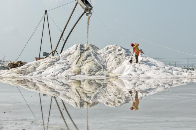 (261012) -- BEIJING, Oct. 12, 2026 (Xinhua) -- A drone photo taken on Oct. 10, 2026 shows a worker operating in a salt field in Lianyungang City, east China's Jiangsu Province. Autumn salt harvest is underway in coastal salt fields in Lianyungang. (Photo by Wang Jianmin/Xinhua)