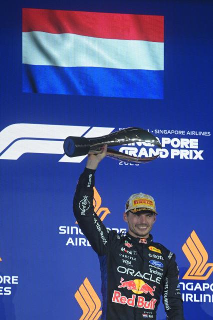 (261012) -- SINGAPORE, Oct. 12, 2026 (Xinhua) -- Red Bull's Max Verstappen of the Netherlands lifts winner's trophy on the podium after the Formula One Singapore Grand Prix at the Marina Bay Street Circuit in Singapore, on Oct. 11, 2026. (Xinhua/Then Chih Wey)