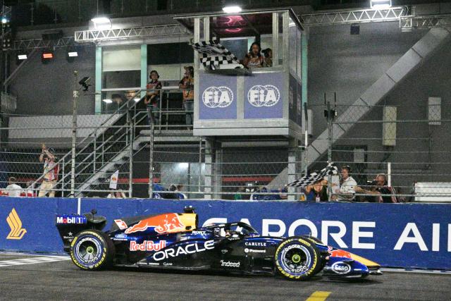 (261012) -- SINGAPORE, Oct. 12, 2026 (Xinhua) -- Red Bull's Max Verstappen of the Netherlands crosses the finish line during the Formula One Singapore Grand Prix at the Marina Bay Street Circuit in Singapore, on Oct. 11, 2026. (Xinhua/Then Chih Wey)