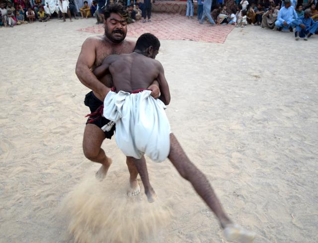 (261012) -- KARACHI, Oct. 12, 2026 (Xinhua) -- Wrestlers compete in a "Sindhi Malakhra" wrestling match in southern Pakistani port city of Karachi on Oct. 11, 2026. Sindhi Malakhra is an ancient form of wrestling that originated in Pakistan's Sindh region. (Str/Xinhua)