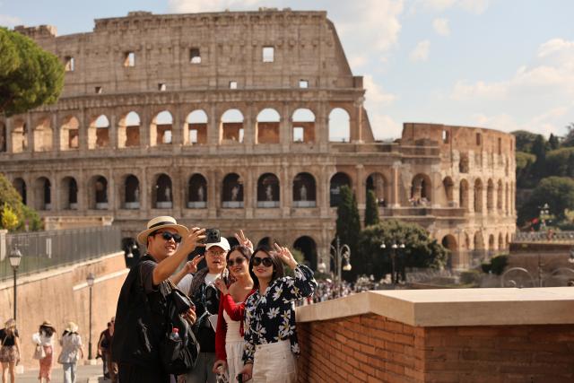 (261012) -- WARSAW, Oct. 12, 2026 (Xinhua) -- Chinese tourists take a selfie with the Colosseum in Rome, Italy, Oct. 4, 2026. (Xinhua/Li Jing)