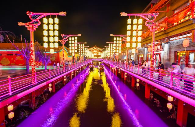 (261012) -- TIANJIN, Oct. 12, 2026 (Xinhua) -- Tourists take boats for sightseeing at the Eastern Acropolis in Binhai New Area of Tianjin, north China, Oct. 11, 2026. Eastern Acropolis, a cultural and tourism complex in Beitang ancient town of Tianjin, launched its trial operation on Sunday. The complex, built upon the town's original infrastructure and themed on Tianjin's history and culture, offers immersive performances, cultural experiences, specialty stores and leisure options for visitors. (Xinhua/Zhao Zishuo)