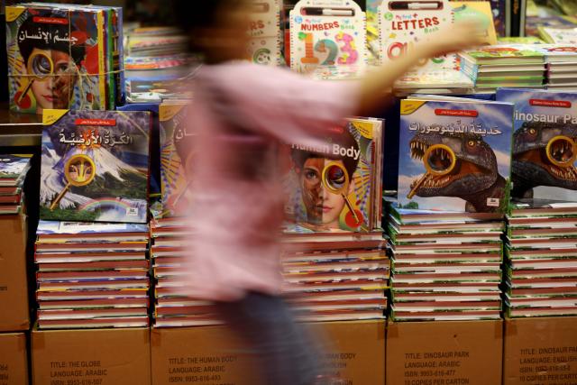 (261012) -- BEIRUT, Oct. 12, 2026 (Xinhua) -- The photo taken on Oct. 11, 2026 shows a visitor walking past book shelves during the Beirut Arab International Book Fair in Beirut, Lebanon. (Xinhua/Bilal Jawich)