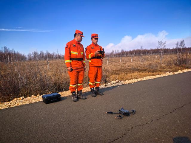 (261012) -- HOHHOT, Oct. 12, 2026 (Xinhua) -- Firefighters prepare to use a drone to observe fire conditions at the border area in north China's Inner Mongolia Autonomous Region, Oct. 11, 2026. More than 2,000 personnel were deployed in north China's Inner Mongolia Autonomous Region to contain a grassland fire spreading from Mongolia, local authorities said on Sunday. (Xinhua)