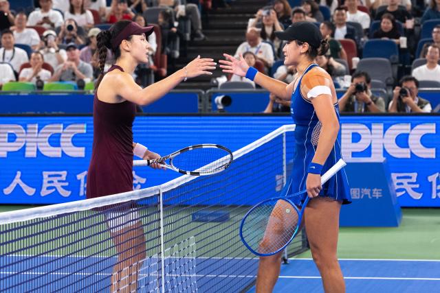 (261012) -- WUHAN, Oct. 12, 2026 (Xinhua) -- Wang Xiyu (R) greets Wang Xinyu after the women's sinlges round of 64 match between Wang Xiyu of China and Wang Xinyu of China of the 2026 Wuhan Open tennis tournament in Wuhan, capital of central China's Hubei Province, Oct. 12, 2026. (Xinhua/Xiao Yijiu)