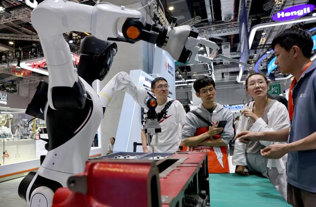 (261012) -- SHANGHAI, Oct. 12, 2026 (Xinhua) -- People visit the 26th China International Industry Fair (CIIF) in east China's Shanghai, Oct. 12, 2026. The 26th CIIF kicked off here on Monday, with the theme of "Intelligent Economy, Limitless Smart Manufacturing." (Xinhua/Fang Zhe)
