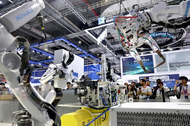 (261012) -- SHANGHAI, Oct. 12, 2026 (Xinhua) -- People visit the 26th China International Industry Fair (CIIF) in east China's Shanghai, Oct. 12, 2026. The 26th CIIF kicked off here on Monday, with the theme of "Intelligent Economy, Limitless Smart Manufacturing." (Xinhua/Fang Zhe)