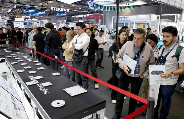 (261012) -- SHANGHAI, Oct. 12, 2026 (Xinhua) -- People visit the 26th China International Industry Fair (CIIF) in east China's Shanghai, Oct. 12, 2026. The 26th CIIF kicked off here on Monday, with the theme of "Intelligent Economy, Limitless Smart Manufacturing." (Xinhua/Fang Zhe)