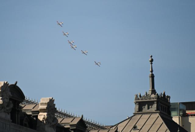 (261012) -- MADRID, Oct. 12, 2026 (Xinhua) -- Aircraft perform during a military parade commemorating the National Day in Madrid, Spain, Oct. 12, 2026. (Xinhua/Cheng Min)