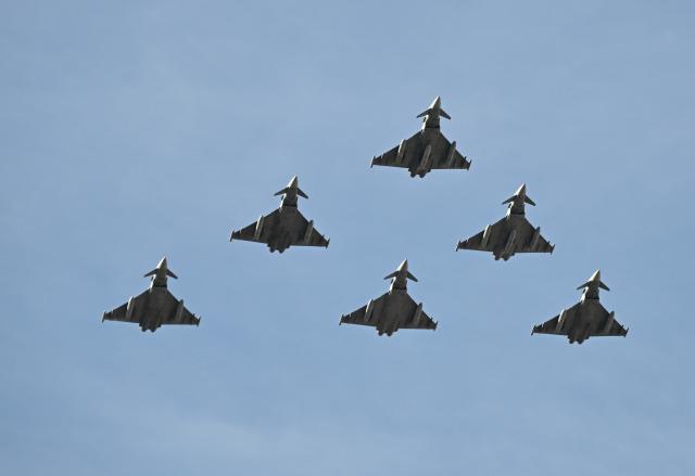 (261012) -- MADRID, Oct. 12, 2026 (Xinhua) -- Aircraft perform during a military parade commemorating the National Day in Madrid, Spain, Oct. 12, 2026. (Xinhua/Cheng Min)