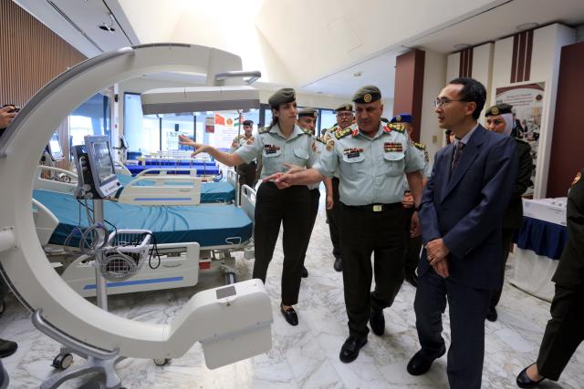 (261012) -- AMMAN, Oct. 12, 2026 (Xinhua) -- Gong Anmin (1st R), charge d'affaires of the Chinese Embassy in Jordan, checks medical supplies donated by China in Amman, Jordan, Oct. 12, 2026. A Chinese donation of medical supplies was handed over to Jordan's Royal Medical Services on Monday to treat sick and wounded Palestinians who have fled Gaza to Jordan. (Photo by Mohammad Abu Ghosh/Xinhua)