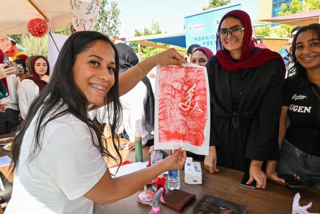 (261012) -- CAIRO, Oct. 12, 2026 (Xinhua) -- A visitor experiences Chinese rubbing during a Chinese culture festival at Badr University in Cairo, Egypt, Oct. 12, 2026. A Chinese culture festival was held Monday at Badr University in Cairo to celebrate the 70th anniversary of the establishment of diplomatic relations between China and Egypt, featuring cultural performances, traditional Chinese arts and student exchanges. (Xinhua/Xin Mengchen)