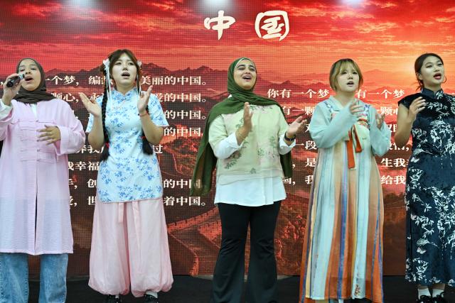 (261012) -- CAIRO, Oct. 12, 2026 (Xinhua) -- Students sing a Chinese song during a Chinese culture festival at Badr University in Cairo, Egypt, Oct. 12, 2026. A Chinese culture festival was held Monday at Badr University in Cairo to celebrate the 70th anniversary of the establishment of diplomatic relations between China and Egypt, featuring cultural performances, traditional Chinese arts and student exchanges. (Xinhua/Xin Mengchen)