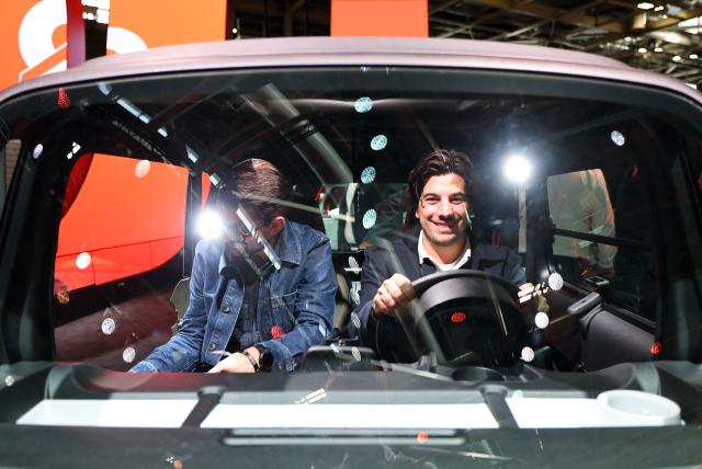 (261012) -- PARIS, Oct. 12, 2026 (Xinhua) -- Visitors try out a vehicle on display at the Paris Motor Show in Paris, France, Oct. 12, 2026. The 2026 Paris Motor Show kicked off here on Monday. (Xinhua/Wu Huiwo)