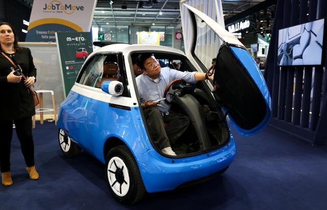 (261012) -- PARIS, Oct. 12, 2026 (Xinhua) -- A visitor tries out a vehicle on display at the Paris Motor Show in Paris, France, Oct. 12, 2026. The 2026 Paris Motor Show kicked off here on Monday. (Xinhua/Wu Huiwo)