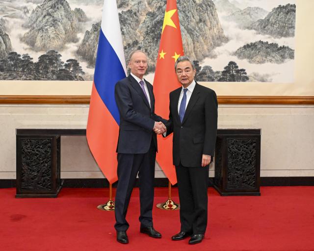 (261012) -- BEIJING, Oct. 12, 2026 (Xinhua) -- Wang Yi, a member of the Political Bureau of the Communist Party of China (CPC) Central Committee and director of the Office of the Foreign Affairs Commission of the CPC Central Committee, meets with Russian presidential aide and chairman of the Maritime Board Nikolai Patrushev in Beijing, capital of China, Oct. 12, 2026. (Xinhua/Tian Yu)