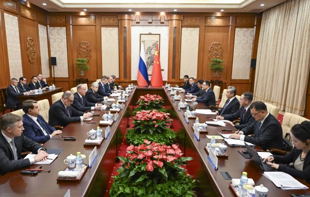 (261012) -- BEIJING, Oct. 12, 2026 (Xinhua) -- Wang Yi, a member of the Political Bureau of the Communist Party of China (CPC) Central Committee and director of the Office of the Foreign Affairs Commission of the CPC Central Committee, meets with Russian presidential aide and chairman of the Maritime Board Nikolai Patrushev in Beijing, capital of China, Oct. 12, 2026. (Xinhua/Tian Yu)