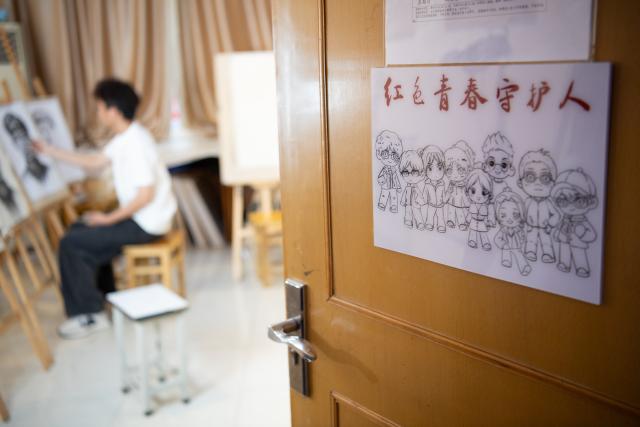 (261013) -- JINZHAI, Oct. 13, 2026 (Xinhua) -- This photo shows the studio of a volunteer team focusing on painting portraits of martyrs, at the Academy of Fine Arts of Anhui Normal University in Wuhu, east China's Anhui Province, Sept. 25, 2026. During this year's Mid-Autumn Festival holiday, a volunteer team from the Academy of Fine Arts of Anhui Normal University was busy in Jinzhai County of Lu'an City in east China's Anhui Province, drawing portraits of Red Army martyrs who participated in the Long March, the historic military maneuver in modern Chinese history, and presented them to the families of the martyrs.
   Since November 2021, the Academy of Fine Arts of Anhui Normal University has formed a team to carry out a series of volunteer services focused on drawing portraits of martyrs. Up to now, hundreds of students have participated in these activities, jointly drawing more than 600 portraits of martyrs, which have become an important way for their families to express feelings of longing.
   Across time and space, the youthful faces of those who had fallen on the battlefield were finally seen again by their families back home.
   Tucked in the Dabie Mountains, Jinzhai county contributed tens of thousands of people to the Communist Party of China (CPC)-led revolution in the first half of the 20th century. A total of 12 main units of the Red Army originated from here.
   Now, the Anhui Normal University project to paint portraits of Red Army martyrs is giving some families a long-awaited face to go with the stories passed down for generations. Usually the volunteer team would first contact the relatives of martyrs and then study photographs of the martyrs' descendants to determine basic facial contours. They would then revise the portraits repeatedly, drawing on family descriptions of the martyrs' eyes, expressions and habitual looks, until these relatives feel the likeness is right.
   For teachers and students of the team, painting portraits of martyrs is not merely a simple sketch creation but also an immersive study tour of revolutionary history. The brows and eyes rendered by the artists' brushes have captured the youthful appearance of the martyrs and also provided a place for the remembrance to rest. The past events recounted by the relatives of the martyrs are a testament to the enduring revolutionary legacy of the Dabie Mountains from generation to generation. (Xinhua/Zhang Duan)