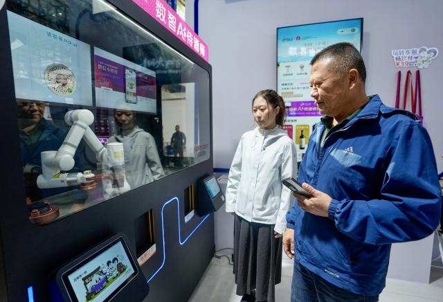 (261013) -- YINCHUAN, Oct. 13, 2026 (Xinhua) -- People experience the AI sommelier service at the sixth China (Ningxia) International Wine Culture and Tourism Expo in Yinchuan, northwest China's Ningxia Hui Autonomous Region, Oct. 13, 2026.
  From Oct. 12 to 14, the expo is held in Yinchuan, attracting 84 world-renowned wineries and enterprises from distinctive production areas in 16 countries. It has also drawn a total of 146 leading domestic wineries from Ningxia and other core production areas in China.
 The local wine industry has also become a driver of tourism. Wineries in Ningxia receive more than 3.7 million tourist visits each year, generating combined benefits of over 50 billion yuan (around 7.4 billion U.S. dollars). (Xinhua/Yang Zhisen)