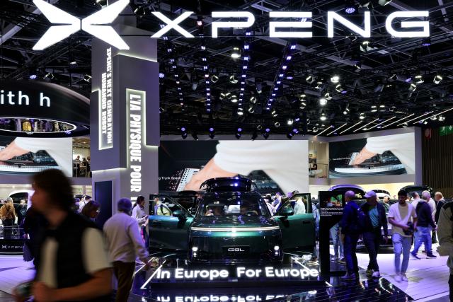 (261013) -- PARIS, Oct. 13, 2026 (Xinhua) -- People visit the booth of Chinese automaker Xpeng during the 2026 Paris Motor Show in Paris, France, on Oct. 13, 2026. The 91st Paris Motor Show opened in the French capital on Monday, with a record number of Chinese automakers taking part to showcase their latest models and technologies. (Xinhua/Wu Huiwo)