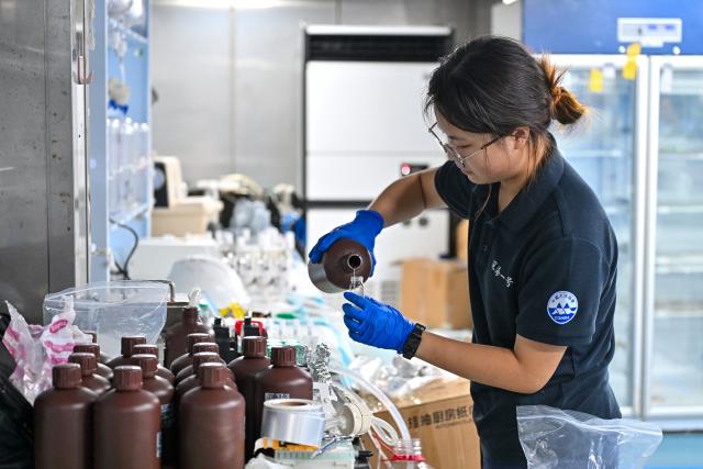 (261013) -- ABOARD RESEARCH VESSEL DEEP SEA NO. 1, Oct. 13, 2026 (Xinhua) -- A staff member processes deep-sea samples collected by the manned deep-sea submersible Jiaolong aboard the research vessel Deep Sea No. 1, on Oct. 11, 2026. China's manned deep-sea submersible Jiaolong successfully completed its 467th dive. The dive reached a depth of approximately 4,400 meters. (Xinhua/Li Xin)