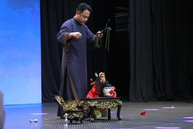 (261013) -- HARARE, Oct. 13, 2026 (Xinhua) -- An artist performs traditional Chinese puppetry on stage during the "Wu Opera in Africa" showcase in Harare, Zimbabwe, on Oct. 12, 2026. TO GO WITH "Feature: Chinese Wu Opera bridges cultures in Zimbabwe" (Xinhua/Tafara Mugwara)