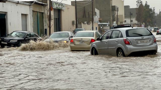 (261013) -- TRIPOLI, Oct. 13, 2026 (Xinhua) -- This photo taken with a mobile phone shows vehicles running on a flooded road after heavy rains in Tripoli, Libya, Oct. 13, 2026. (Photo by Hazem Turkia/Xinhua)