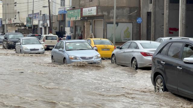 (261013) -- TRIPOLI, Oct. 13, 2026 (Xinhua) -- This photo taken with a mobile phone shows vehicles running on a flooded road after heavy rains in Tripoli, Libya, Oct. 13, 2026. (Photo by Hazem Turkia/Xinhua)