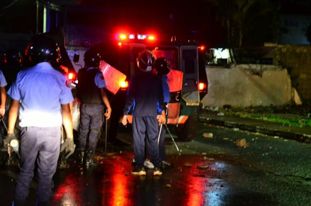 (261013) -- PORT LOUIS, Oct. 13, 2026 (Xinhua) -- Law enforcement officers guard on the street in Saint-Croix, outskirts of Port Louis, Mauritius, late Oct. 12, 2026. Mauritian Prime Minister Navinchandra Ramgoolam announced in a televised address on Tuesday evening that a curfew would be in effect in the country from 8:30 p.m. local time Tuesday until 6:00 a.m. local time Wednesday. (Str/Xinhua)