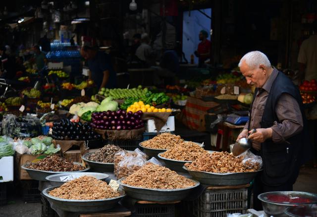 (261013) -- DAMASCUS, Oct. 13, 2026 (Xinhua) -- A vendor displays dried fruits at the central market in downtown Damascus, Syria, Oct. 13, 2026. (Photo by Ammar Safarjalani/Xinhua)