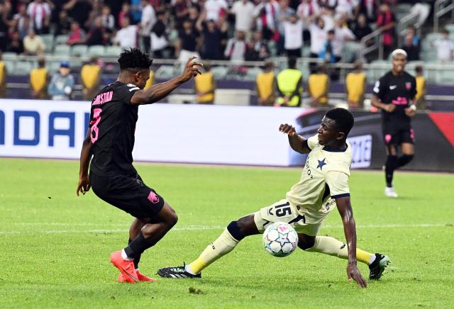(261014) -- BAKU, Oct. 14, 2026 (Xinhua) -- Christian Nwachukwu (L) of Sabah FK vies for the ball with Mubarak Suleiman of Slavia Praha during the UEFA Champions League League Stage match in Baku, Azerbaijan, on Oct. 13, 2026. (Photo by Tofik Babayev/Xinhua)