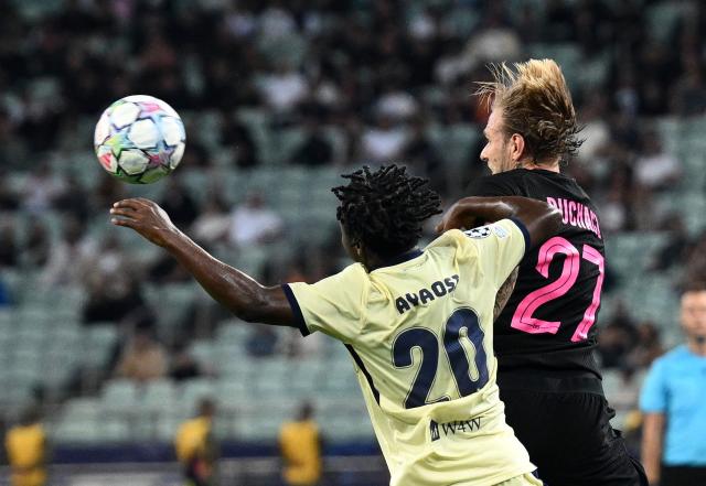 (261014) -- BAKU, Oct. 14, 2026 (Xinhua) -- Emmanuel Ayaosi (L) of Slavia Praha and Tymoteusz Puchacz of Sabah FK compete for a header during the UEFA Champions League League Stage match in Baku, Azerbaijan, on Oct. 13, 2026. (Photo by Tofik Babayev/Xinhua)