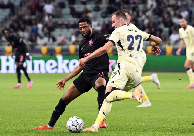 (261014) -- BAKU, Oct. 14, 2026 (Xinhua) -- Kaheem Parris (L) of Sabah FK vies for the ball with Tomas Vlcek of Slavia Praha during the UEFA Champions League League Stage match in Baku, Azerbaijan, on Oct. 13, 2026. (Photo by Tofik Babayev/Xinhua)