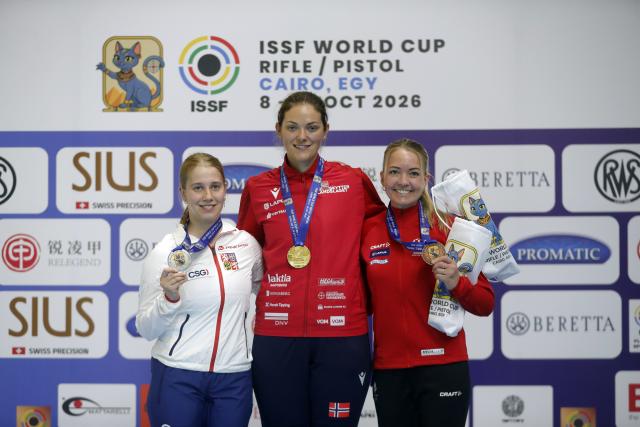 (261014) -- CAIRO, Oct. 14, 2026 (Xinhua) -- Gold medalist Jeanette Hegg Duestad (C) of Norway, silver medalist Veronika Blazickova (L) of the Czech Republic and bronze medalist Rikke Maeng Ibsen of Denmark pose for a photo during the awarding ceremony for the 50m rifle three positions women's final at the International Shooting Sport Federation (ISSF) World Cup Rifle/Pistol in Cairo, Egypt, on Oct. 13, 2026. (Xinhua/Ahmed Gomaa)