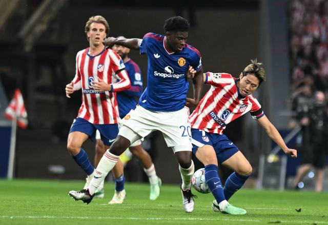 (261014) -- MADRID, Oct. 14, 2026 (Xinhua) -- Lee Kang-In (R) of Atletico Madrid vies with Carlos Baleba (C) of Manchester United during the UEFA Champions League League Stage football match between Atletico Madrid and Manchester United in Madrid, Spain, Oct. 13, 2026. (Xinhua/Cheng Min)