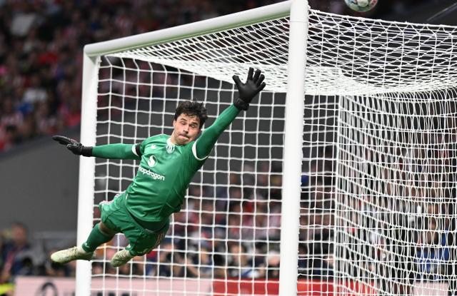(261014) -- MADRID, Oct. 14, 2026 (Xinhua) -- Senne Lammens of Manchester United makes a save during the UEFA Champions League League Stage football match between Atletico Madrid and Manchester United in Madrid, Spain, Oct. 13, 2026. (Xinhua/Cheng Min)