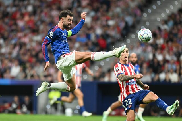 (261014) -- MADRID, Oct. 14, 2026 (Xinhua) -- Bruno Fernandes (top) of Manchester United competes during the UEFA Champions League League Stage football match between Atletico Madrid and Manchester United in Madrid, Spain, Oct. 13, 2026. (Xinhua/Cheng Min)