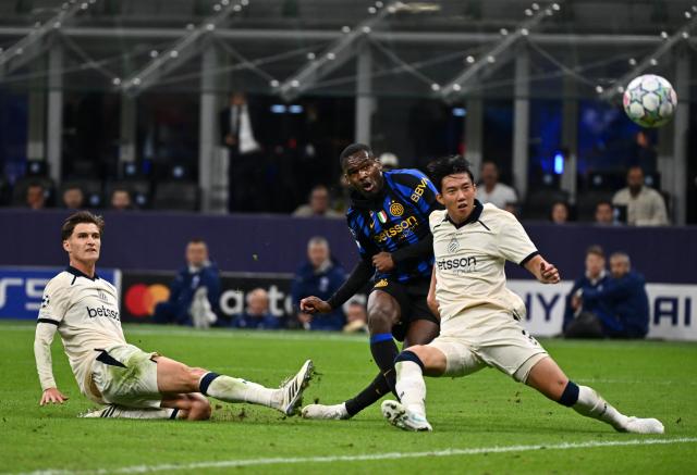 (261014) -- MILAN, Oct. 14, 2026 (Xinhua) -- Inter Milan's Ange Yoan Bonny (C) shoots to score during the UEFA Champions League League Stage football match between Inter Milan and Club Brugge in Milan, Italy, Oct. 13, 2026. (Photo by Augusto Casasoli/Xinhua)