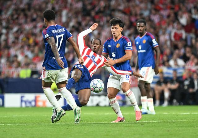 (261014) -- MADRID, Oct. 14, 2026 (Xinhua) -- Thomas Lemar (C) of Atletico Madrid competes during the UEFA Champions League League Stage football match between Atletico Madrid and Manchester United in Madrid, Spain, Oct. 13, 2026. (Xinhua/Cheng Min)