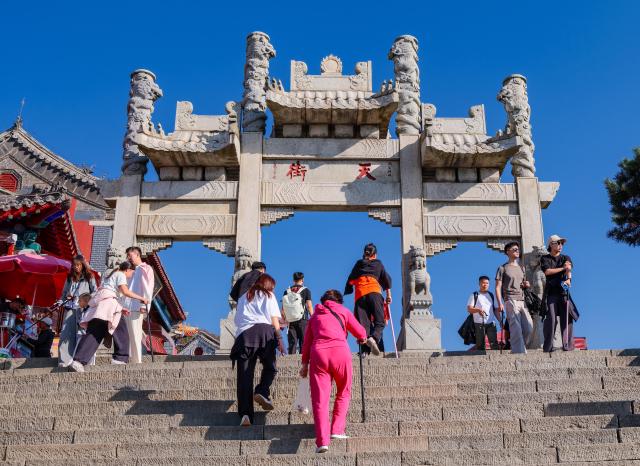 (261014) -- TAI'AN, Oct. 14, 2026 (Xinhua) -- This photo taken on Oct. 7, 2026 shows tourists visiting the Mount Tai in Tai'an City, east China's Shandong Province. Mount Tai, a UNESCO World Heritage Site, is one of China's most renowned mountains, known for its historical, cultural, aesthetic, and scientific significance. (Xinhua/Chen Yehua)