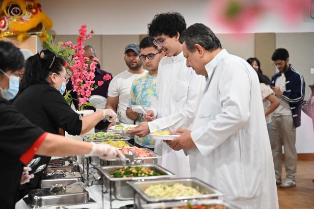 (261014) -- HAWALLI GOVERNORATE, Oct. 14, 2026 (Xinhua) -- People taste dumplings during a Chinese culinary experience event in Hawalli Governorate, Kuwait, Oct. 13, 2026. Titled "The Taste of China: Jiaozi (Dumpling) Experience," the event was organized by the China Cultural Center in Kuwait to introduce traditional Chinese food culture to local residents. More than 100 people participated in the event. (Photo by Asad/Xinhua)