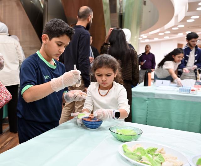 (261014) -- HAWALLI GOVERNORATE, Oct. 14, 2026 (Xinhua) -- People participate in a Chinese culinary experience event in Hawalli Governorate, Kuwait, Oct. 13, 2026. Titled "The Taste of China: Jiaozi (Dumpling) Experience," the event was organized by the China Cultural Center in Kuwait to introduce traditional Chinese food culture to local residents. More than 100 people participated in the event. (Photo by Asad/Xinhua)