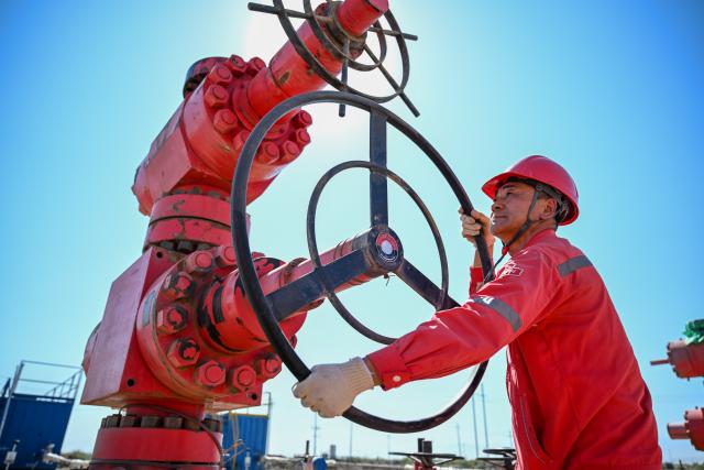 (261014) -- BEIJING, Oct. 14, 2026 (Xinhua) -- A staff member inspects equipment in Jiqing Oilfield operation area of Xinjiang Oilfield Company of China National Petroleum Corporation (CNPC) in northwest China's Xinjiang Uygur Autonomous Region, Aug. 30, 2026. (Xinhua/Ding Lei)