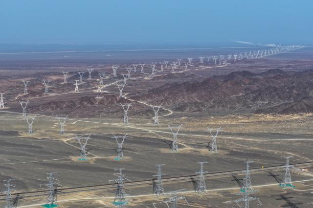 (261014) -- BEIJING, Oct. 14, 2026 (Xinhua) -- An aerial drone photo shows auxiliary lines of the Hami-Chongqing ±800 kV ultra-high voltage direct current transmission project, in Hami, northwest China's Xinjiang Uygur Autonomous Region, March 21, 2025. (Xinhua/Ding Lei)