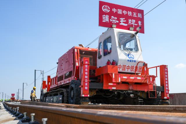 (261014) -- NANJING, Oct. 14, 2026 (Xinhua) -- This photo taken on Oct. 14, 2026 shows constructors laying tracks on the Nantong-Ningbo high-speed railway in east China's Jiangsu Province. A high-speed railway linking Nantong of east China's Jiangsu Province with Ningbo of east China's Zhejiang Province started its track laying on Wednesday. The project is an important part of the coastal channel of China's high-speed rail network, which features eight north-south vertical lines and eight east-west horizontal lines. The new line will promote the high-quality integrated development of the Yangtze River Delta after its completion. (Xinhua/Li Bo)