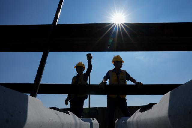 (261014) -- NANJING, Oct. 14, 2026 (Xinhua) -- This photo taken on Oct. 14, 2026 shows constructors laying tracks on the Nantong-Ningbo high-speed railway in east China's Jiangsu Province. A high-speed railway linking Nantong of east China's Jiangsu Province with Ningbo of east China's Zhejiang Province started its track laying on Wednesday. The project is an important part of the coastal channel of China's high-speed rail network, which features eight north-south vertical lines and eight east-west horizontal lines. The new line will promote the high-quality integrated development of the Yangtze River Delta after its completion. (Xinhua/Li Bo)