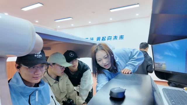 (261014) -- CHENGDU, Oct. 14, 2026 (Xinhua) -- Ngorcog (1st R) instructs trainees during a flight simulator training session in Ruoergai County, southwest China's Sichuan Province, July 15, 2026. TO GO WITH "China Focus: Drones rise over grassland the Red Army once crossed" (Xinhua)