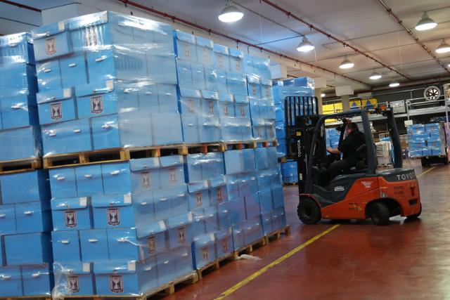 (261014) -- MODIIN, Oct. 14, 2026 (Xinhua) -- A worker transfers ballot boxes at a logistics center near the central Israeli city of Modiin, Oct. 14, 2026. The general elections for Israel's Knesset, the country's parliament, will be held on Oct. 27. All the preparations for the election are underway. (Photo by Gil Cohen Magen/Xinhua)